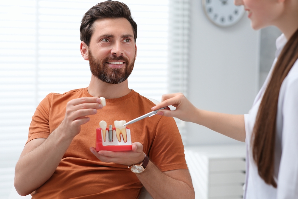 How do dental implants affect the teeth next to them?